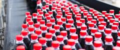 Water bottling line for processing and bottling black carbonated juice into bottles.