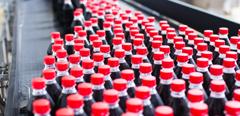 Water bottling line for processing and bottling black carbonated juice into bottles.