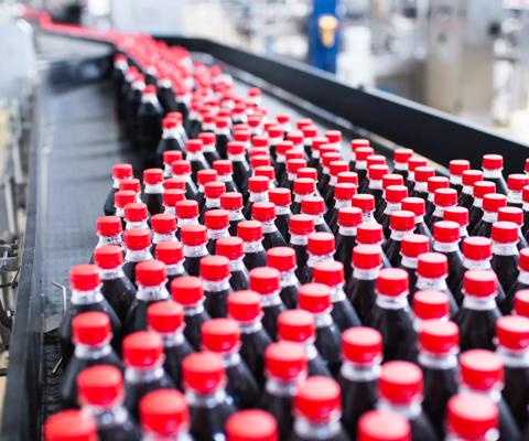Water bottling line for processing and bottling black carbonated juice into bottles.