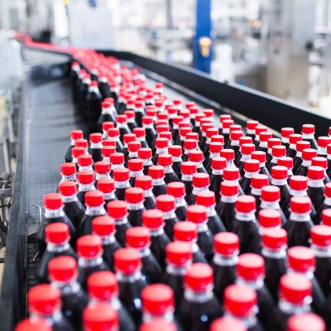 Water bottling line for processing and bottling black carbonated juice into bottles.