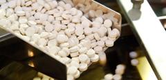 2009Jun-stock-medicine-tablet-pill-production-rails-closeup-pharmaceuticals
