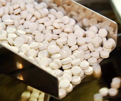 2009Jun-stock-medicine-tablet-pill-production-rails-closeup-pharmaceuticals