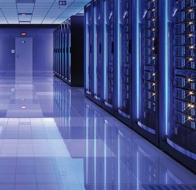Servers behind glass in a hallway from a data center with blue lights