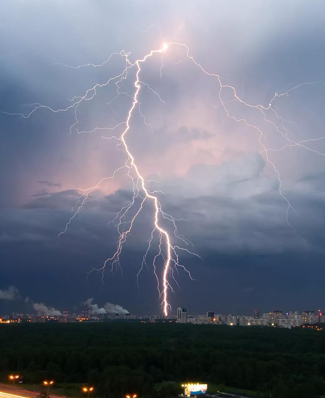 Photo of a lightning strike over a city