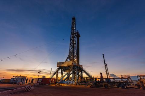Sunrise scenery of inland drilling rig in drill site of oil field, petroleum industry
