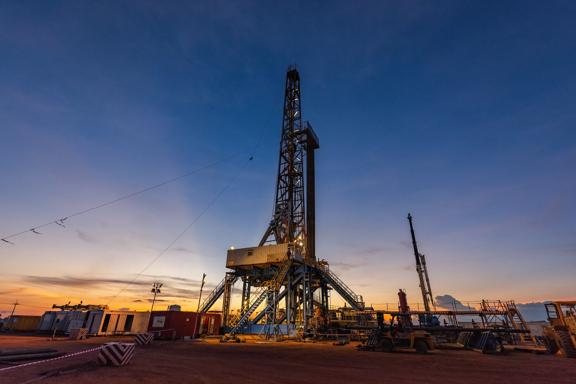 Sunrise scenery of inland drilling rig in drill site of oil field, petroleum industry