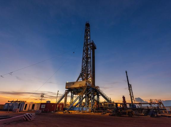 Sunrise scenery of inland drilling rig in drill site of oil field, petroleum industry