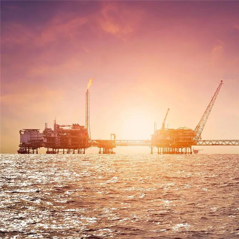 Offshore construction platform for production oil and gas with sunset sky
