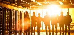 Abstract data center in futuristic steel and glass structure room with Internet business team