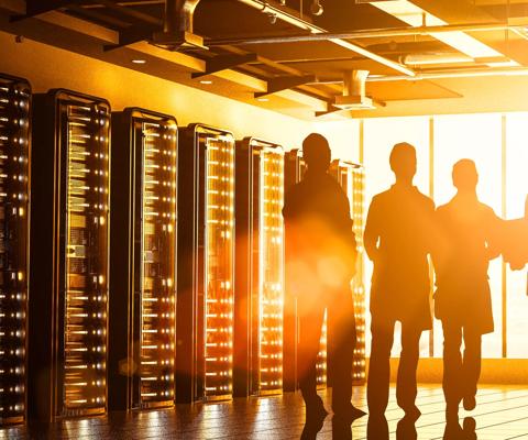 Abstract data center in futuristic steel and glass structure room with Internet business team