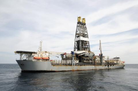 A drill ship at open ocean drilling location. Ship has helideck at bow and a double drill tower. Drill ships can drill in deeper water than many other offshore drilling platforms. They are often used for exploratory drilling as well as to drill  production wells. A type of off shore oil rig.