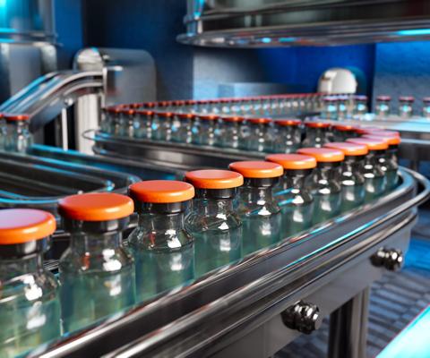 Vaccines in a pharmaceutical factory's production line are shown in a 3D rendering.