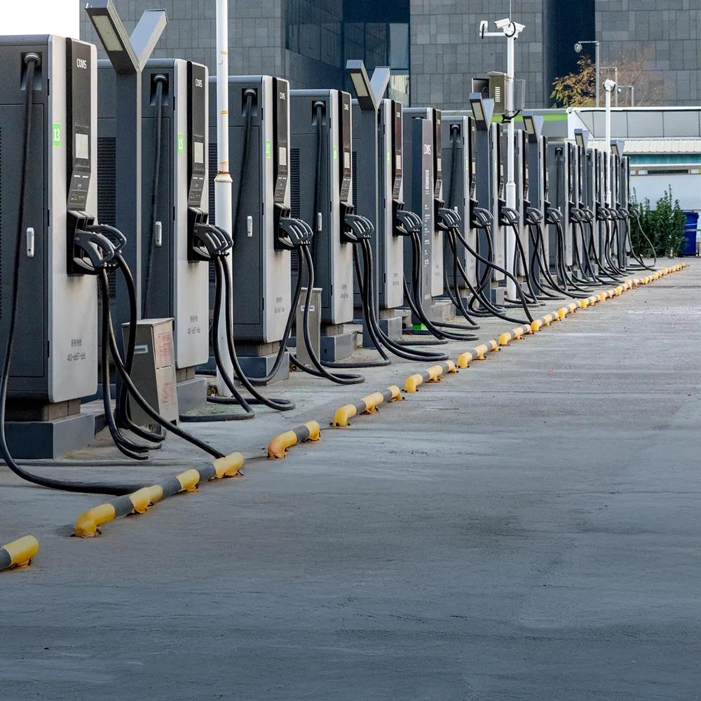 Row of electric vehicle fast charging stations installed outdoors in an urban area