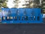 A large blue air cooled fluid chiller with multiple cooling units.