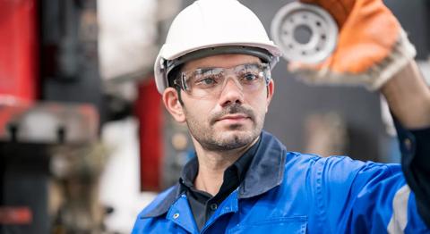 Quality Control Assurance in auto part industry. Quality Control Engineer inspecting accuracy of engineering part by visual check compare with quality standard in production line shopfloor.