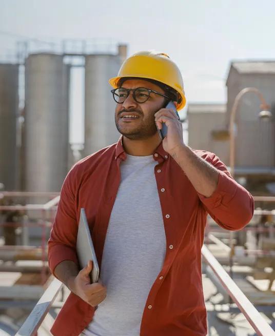 Mechanical contractor stands among units at a job site