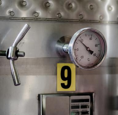 A measuring device attached to the grey manufacturing equipment