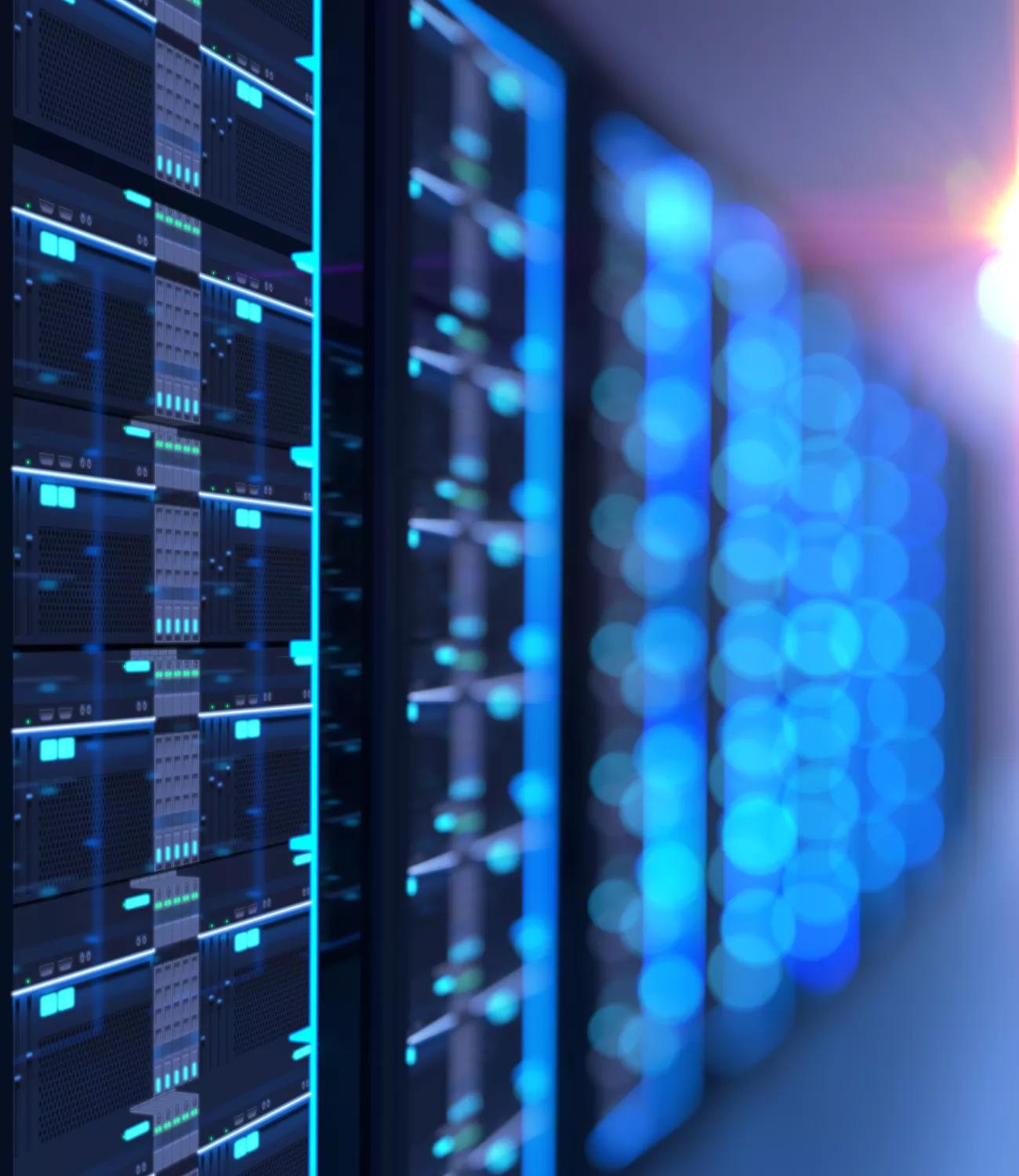 A dark, shallow-focus shot on a row of server racks, with numerous small, glowing blue lights and digital readouts on the server faces.