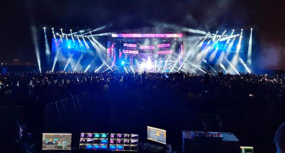 View of the control center of a concert, with the stage in the background.