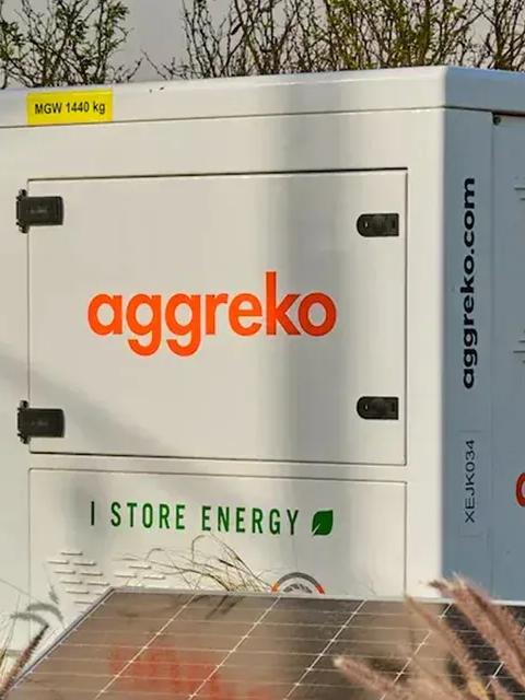 Aggreko battery energy storage system surrounded by solar panels.