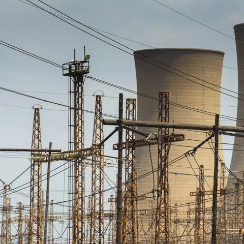 Cooling towers and electricity pylons. Photographer: Waldo Swiegers/Bloomberg