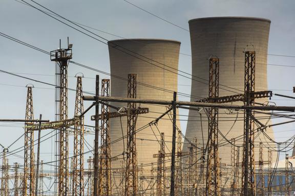Cooling towers and electricity pylons. Photographer: Waldo Swiegers/Bloomberg