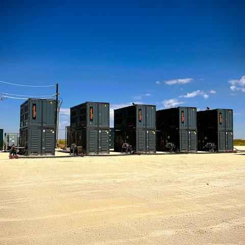 Shot of a field power generation setup in a remote, sunny, dry environment.  