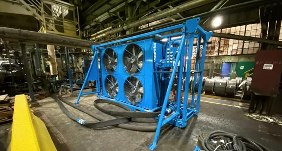 Big, blue Aggreko cooling unit in a warehouse.
