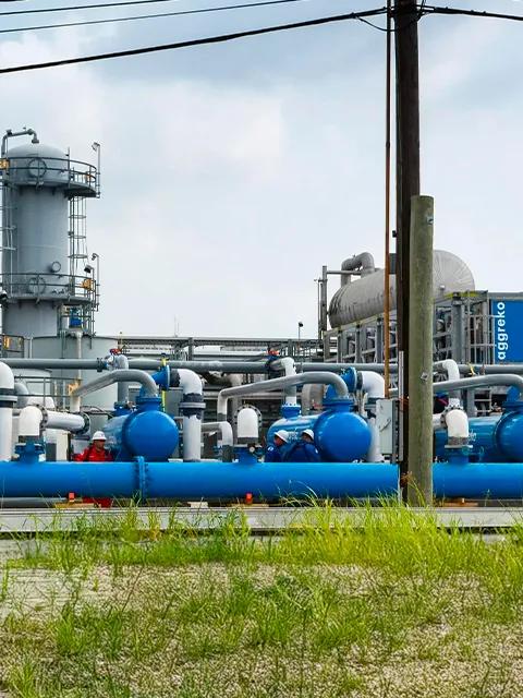 View of complex industrial piping and vertical processing towers.