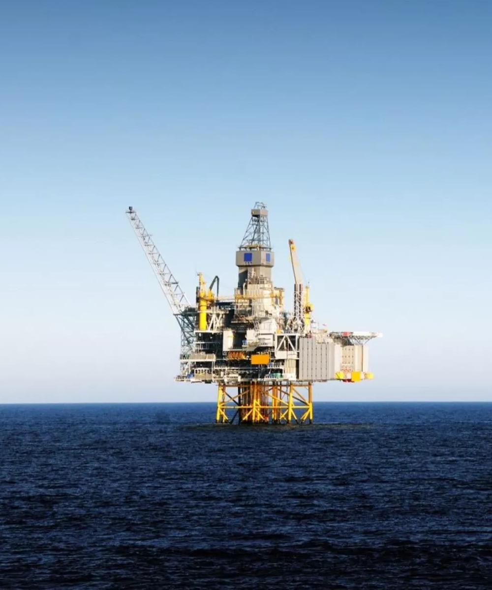 An oil rig in the sea seen from sea level.