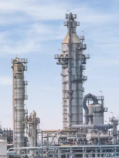 Ground view of a refinery's towers.