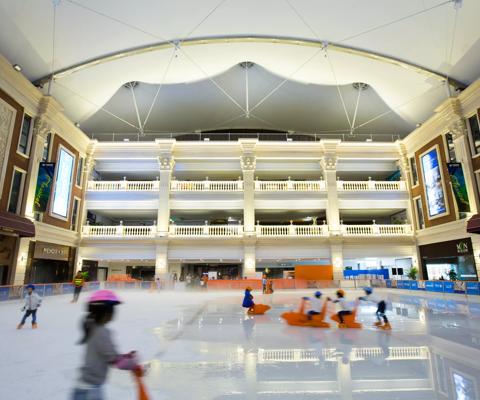 Children learning to skate at ice rink in Shanghai