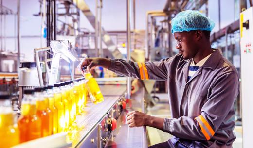 Africa, Quality, Worker - Production Line Worker checking random bottles.