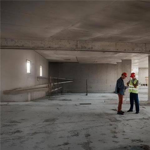 2 workers in uniform at a construction site