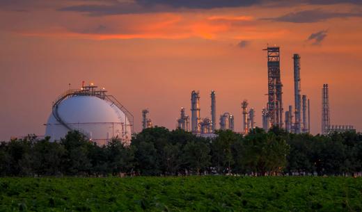 Petroleum storage tanks on petrochemical plant over sunset