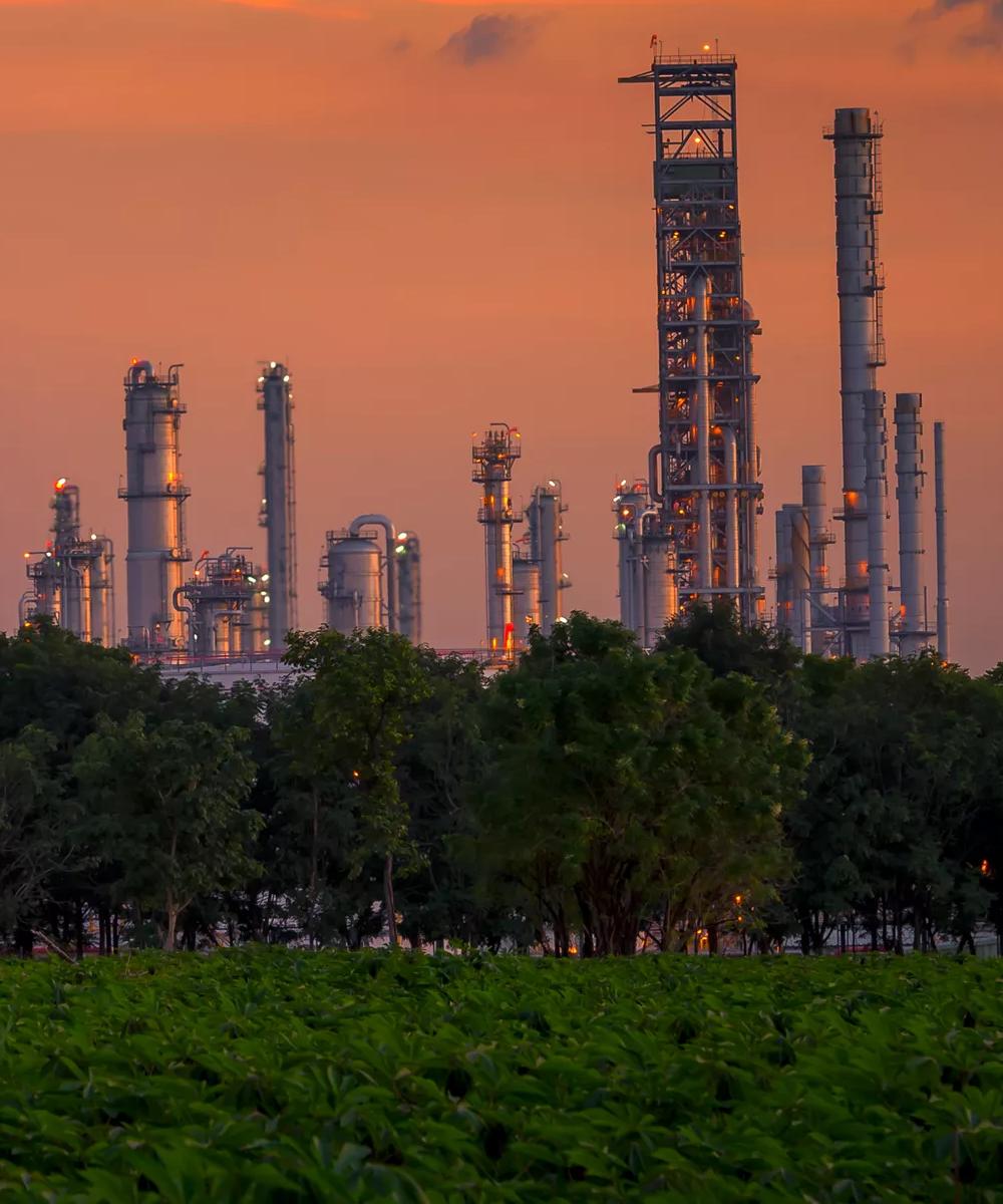 View of a petrochemical plant during an orange sunset.