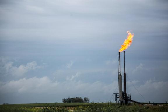 A flare stack burning off gas from on oil well.