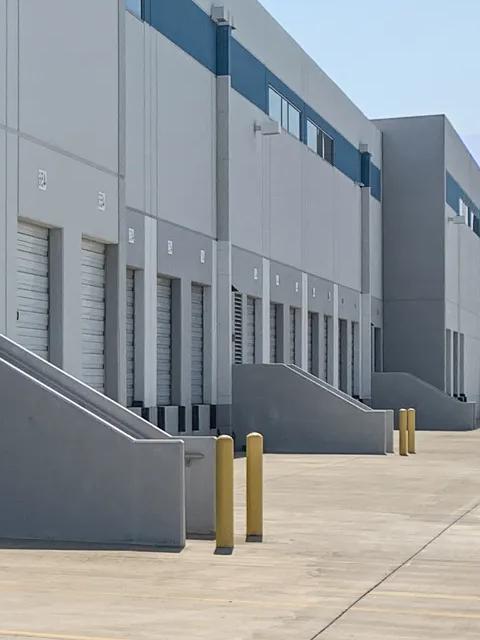 Exterior of warehouse facility with text overlay
