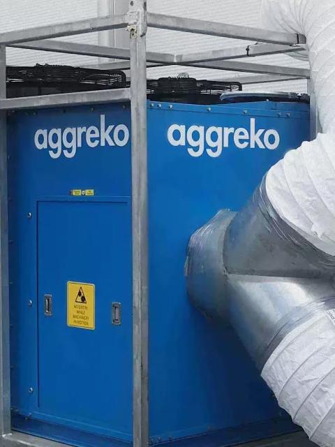 Aggreko cooling unit connected to large flexible air ducts.