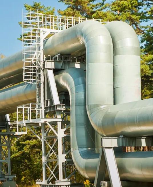 White pipeline in a desert with red tones