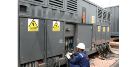 A technician working on an Aggreko transformer