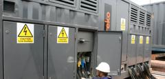 A technician working on an Aggreko transformer