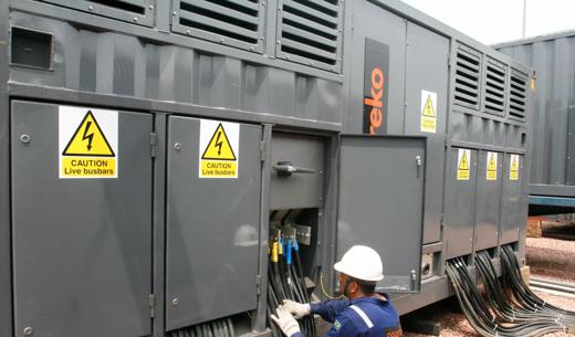 A technician working on an Aggreko transformer