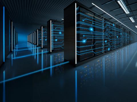 A view down a long, dark data center aisle. Rows of black server racks are highlighted by vertical strips of bright blue light.