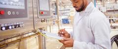 African / Zambian Factory Workers monitoring Electrical Panel in Beverages Factory Factory