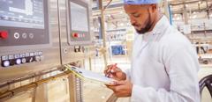 African / Zambian Factory Workers monitoring Electrical Panel in Beverages Factory Factory