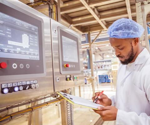 African / Zambian Factory Workers monitoring Electrical Panel in Beverages Factory Factory