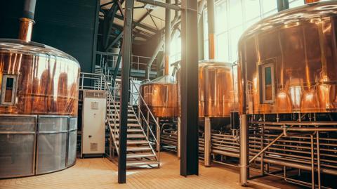 Brewery equipment. Brew manufacturing. Round cooper storage tanks for beer fermentation and maturation