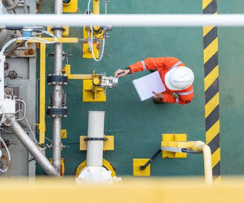 Oil and gas industry activity, operator check and inspect oil pump differential gauge and pressure transmitter as daily log sheet record for monitor production process.