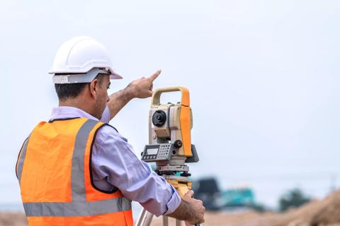 Surveyor and survey equipment on construction site, Land and soil development, Survey equipment, Theodolite for measurement construction work, Civil engineer.